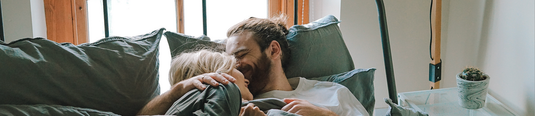 A man in bed with his partner