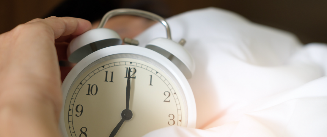 A clock on a bed - how to relax the mind and unwind before bed