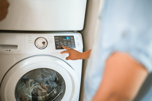 Man washing a mulberry silk pillowcase in a washing machine