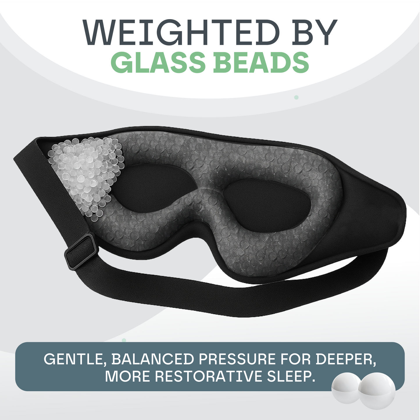 Black sleep mask with glass beads on a light gray background
