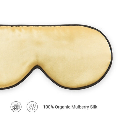 A gold silk sleep eye mask made from organic mulberry silk