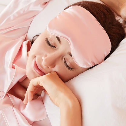 Woman wearing pink silk sleep mask