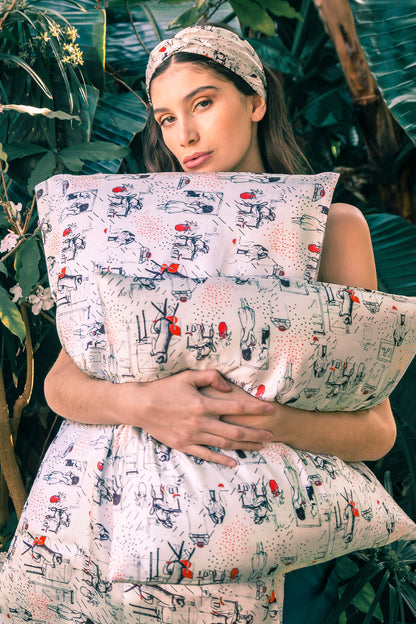 Model holding a silk pillowcase and wearing a mulberry silk headband