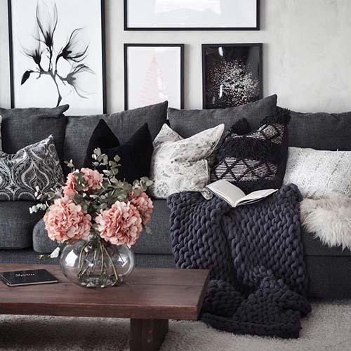 A knitted weighted blanket on a sofa in a stylish home